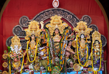Divine idol of Hindu Goddess Durga slaying buffalo demon Mahishasura (asura), inside a puja pandal (temporary resting place for idol) during Durga puja festival in Kolkata, West Bengal.