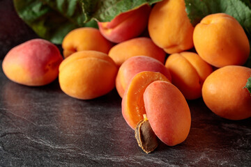 Apricots on a black stone table.