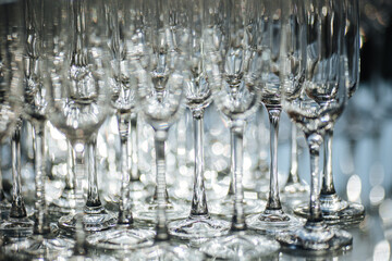 Group of empty and transparent champagne glasses in a restaurant. 