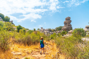 A young woman trekking in Torcal de Antequera on the green and yellow trail, Malaga