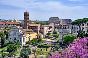 Fototapeta na wymiar A beautiful view of Fori Imperiali, Fori Romani and Rome Coliseum on a sunny day.