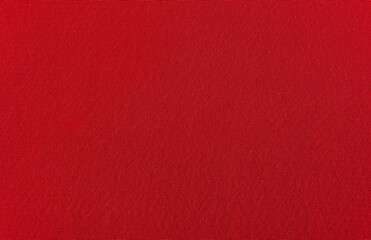 The background is made of red material. Fabric for sewing clothes in a dark shade. Texture