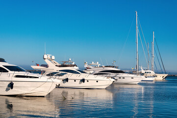 Fototapeta premium Bodrum Cruise Port southwestern Aegean sea harbor. A stunning view of sailing yachts in Port. Yachts in sunset bay. Sailing boats sunset scene. Sunset yachts view. Yachts in sunset bay