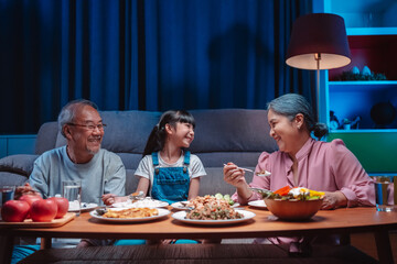 Asian happy family having lunch on dinner japanese table smiling together. little kid daughter enjoy eating food grandparents. Happiness time people lifestyle concept.