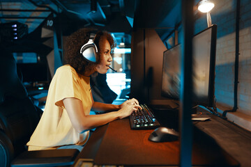 A young cyber gamer girl plays rpg games and shooters.