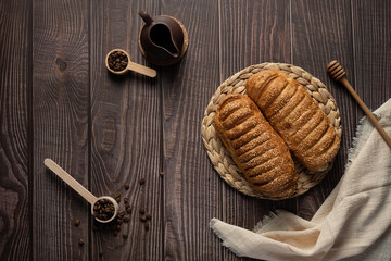 Valavan is a very soft airy puff pastry bun with condensed milk, valavan on a wooden table top view, with copy space, on a dark wooden background, sweets and pastries