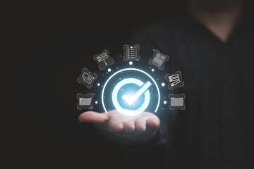Businessman holding virtual document and mark correct sign for online approve paperless and quality assurance concept.