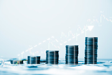 Fototapeta premium Coins stacking with increasing graph stock market graph chart for business investment and stock market analysis concept.