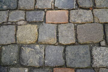 Historic old cobblestones of Herren Street in the old town of Plauen, Vogtlandkreis, Saxony, Germany. Old pavement road. Texture of stone pavement tiles.
