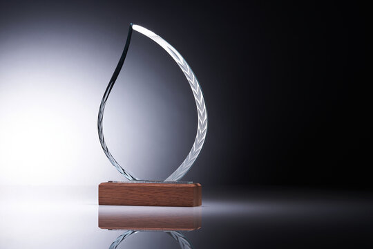 Crystal or glass trophy against gray background