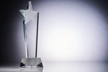 star shape of crydtal glass trophy against gray background