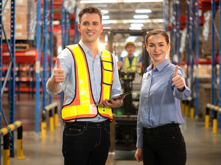 Distribution warehouse manager and client businesswoman using digital tablet checking inventory storage on shelf. Storehouse supervisor worker and logistic engineer standing together at storage room.