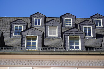 Similar roof bays with old slate cladding on gabled dormer windows in the old town, Plauen city,...
