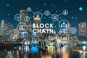 Fototapeta premium City view panorama of Boston Harbour and Seaport Blvd at night time, Massachusetts. Decentralized economy. Building exteriors of financial downtown. Blockchain and cryptography concept, hologram
