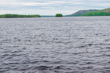 Panorama of the lake before the rain. Thunderclouds over the lake