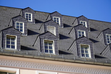 Similar roof bays with old slate cladding on gabled dormer windows in the old town, Plauen city, Vogtland district, Saxony, Germany.