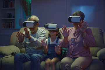 Asian elderly with child play VR video game, family entertainment, granddaughter and grandparents playing together exciting interesting video games using virtual reality headsets living room at home