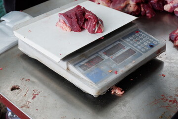 East Jakarta, Indonesia - July 12, 2022: A piece of beef is being weighed on scales