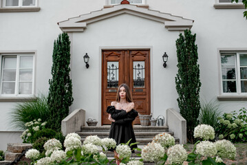 portrait of a beautiful girl on a background of green leaves