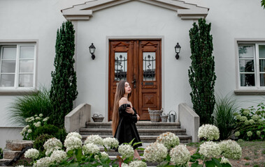 portrait of a beautiful girl on a background of green leaves