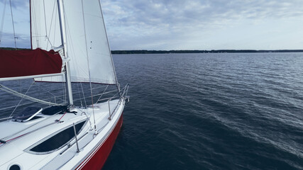 Quarterdeck sailing or yacht race on calm water summer evening. Regatta