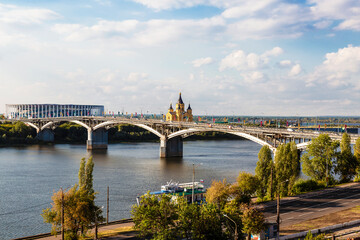 View of the Kanavinsky Bridge across the Oka River, the Alexander Nevsky Cathedral and the building "Nizhny Novgorod" stadium on a sunny summer day. Nizhny Novogod, Russia