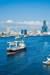 The container ship is leaving the Port of Kaohsiung, Taiwan.