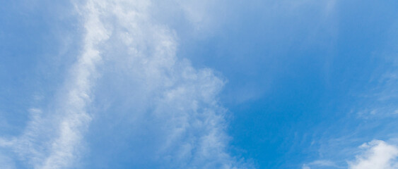 The blue sky and white clouds float in the sky on a clear day with warm sunlight. combined with the cool breeze blowing into the body This results in a wonderfully heavenly freshness.