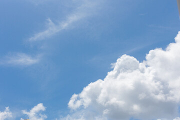 The blue sky and white clouds float in the sky on a clear day with warm sunlight. combined with the cool breeze blowing into the body This results in a wonderfully heavenly freshness.