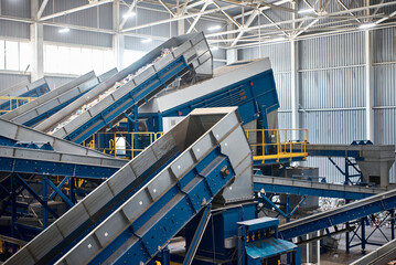 System of conveyors carrying trash at waste processing plant
