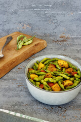 Mogri Aloo Ki Sabzi meal in a bowl. Radish pods with potatoes vegetable dish. Indian cuisine.