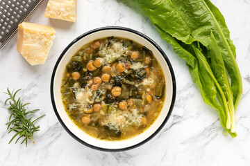Chicory and chickpea soup with Parmesan (zuppa di ceci e cicoria con parmigiano). Italian cuisine.