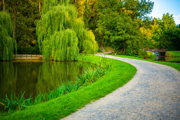 View of Pruhonice park with plants and pond near a castle, Czech Republic 