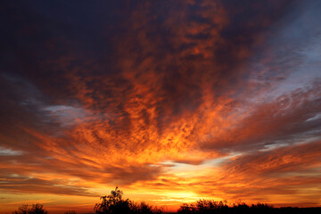 Fototapeta na wymiar an enchanting sunrise with dramatic clouds illuminated by the rising sun