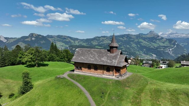 Fronalpstock Klingenstock wooden chapel in Stoos in central Switzerland a small wintersport ski resort village. Grassland alps alpine town on a clear sunny summer day. Clear mountain air and sky.