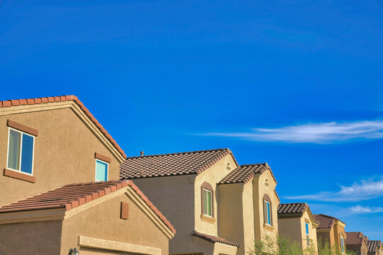 View of peaks of houses with clay tile roofs in Tucson, Arizona