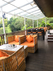 Pretty cozy decor of big terrace with sofa and coffee table