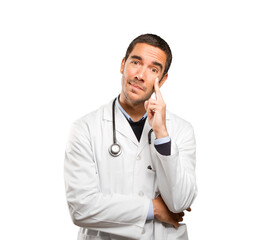 Doubtful doctor against white background