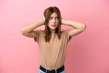 Young English woman isolated on pink background frustrated and covering ears