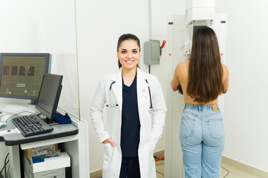 Happy female doctor getting a good diagnosis while doing a mammography test
