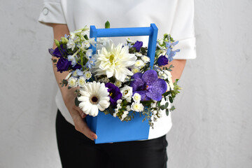 flowers in  hat box. woman with a bouquet of flowers. online catalog of flower delivery shop. plant  composition