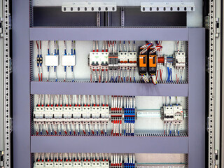 Voltage switchboard with circuit breakers. Electric background. Electric switchboard with wires...