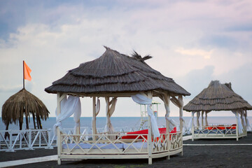 beach bungalow houses on the sea at sunset