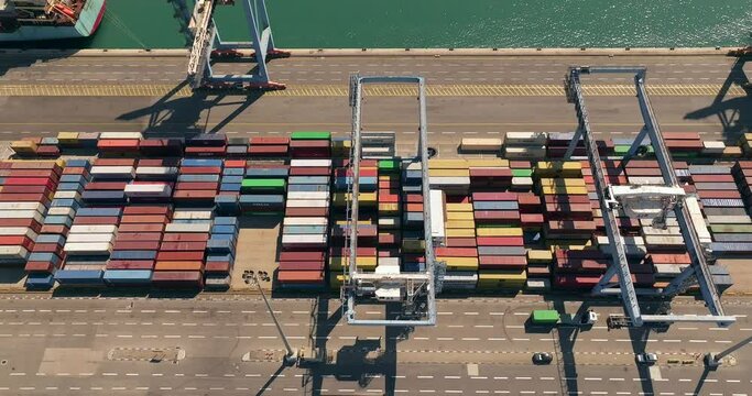 Port dock with Shipping Containers, transtainer cranes, new cars and Container ship. 

