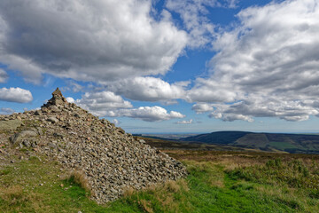 The View East at the Stone Cairn of Cairn O&Otilde;Mount in Aberdeenshire on a fine Autumn day in September with scattered Cloud above.
