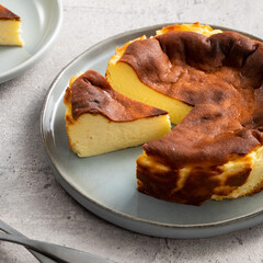 Delicious sliced baked Basque Burnt Cheesecake in a plat served for eating.