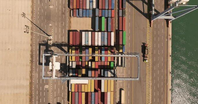 Port dock with Shipping Containers, transtainer cranes, new cars and Container ship. 
