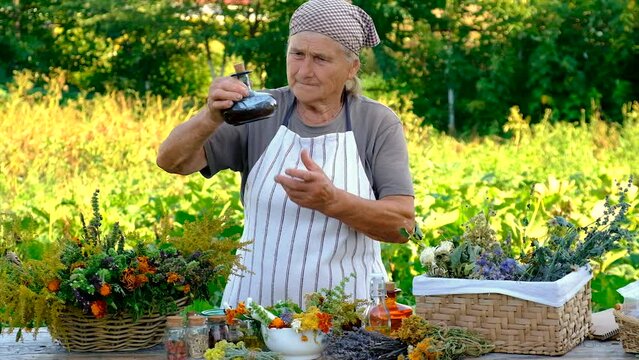 Tinctures and extracts of herbs in a jar woman. Selective focus.