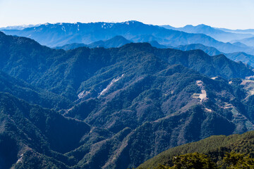 Fototapeta premium Layers of magnificent mountains and clear clouds background in the morning.