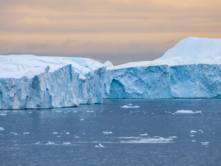 Enormous icebergs seen during the midnight sun, Disko Bay north of the Artic Circle near Ilulissat, Western Greenland